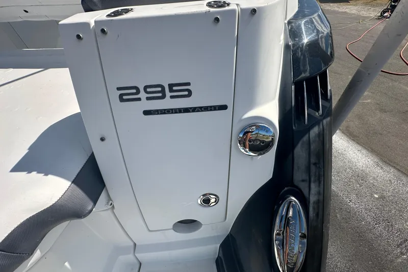 Slide: The Image of 2016 Monterey 295 Sport Yacht interior with seating and helm, under sunny skies. - 16