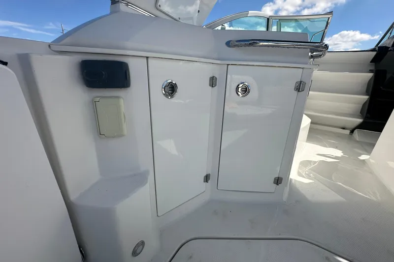 Slide: The Image of 2016 Monterey 295 Sport Yacht interior with white seating and stainless steel accents. - 18