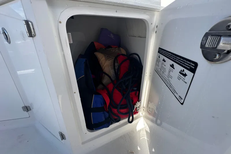 Slide: The Image of Interior of a 2016 Monterey 295 Sport Yacht, featuring sleek white seating and modern controls. - 35