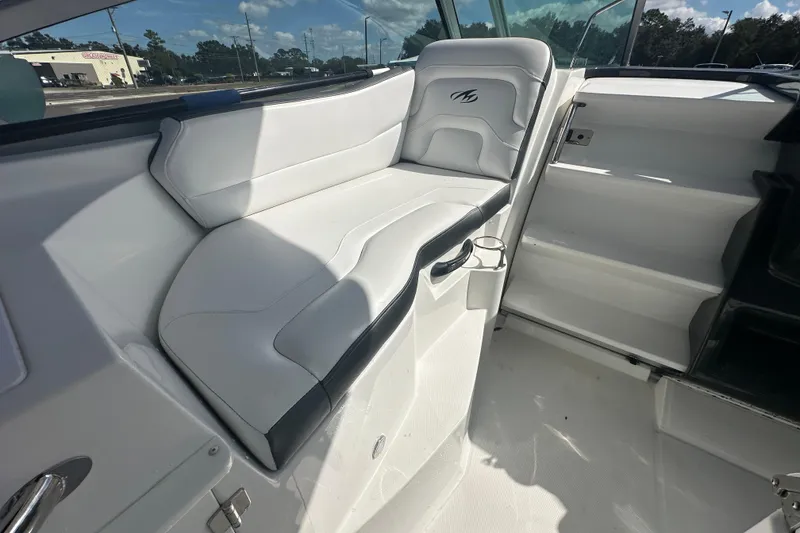 Slide: The Image of 2016 Monterey 295 Sport Yacht interior with white seating and sleek design. - 36