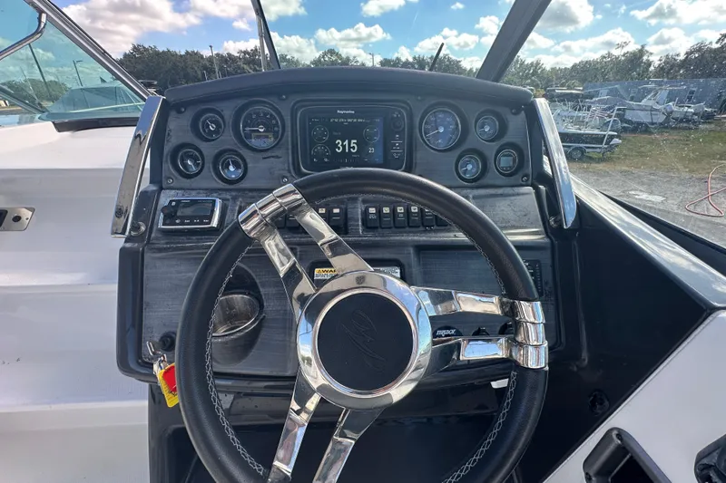 Slide: The Image of 2016 Monterey 295 Sport Yacht interior with white seating and cup holder. - 39