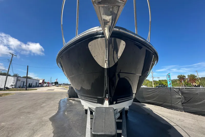 Slide: The Image of 2016 Monterey 295 Sport Yacht on trailer, sleek black hull, clear sky background. - 4