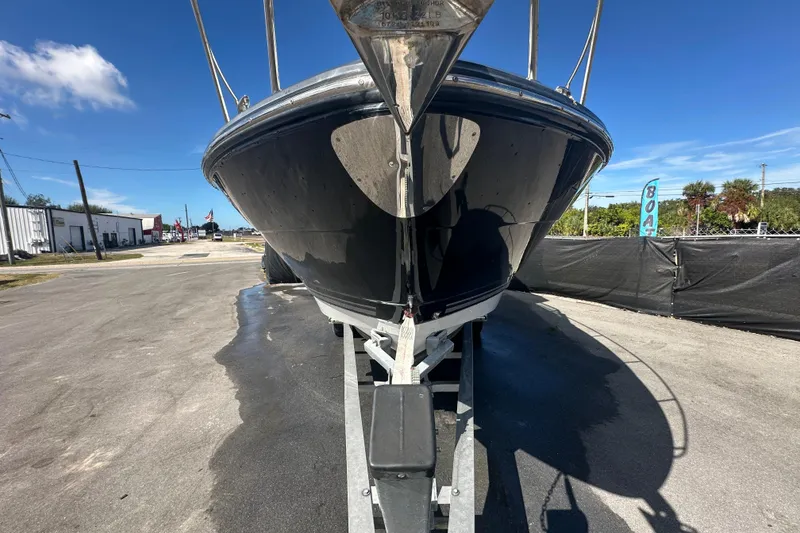 Slide: The Image of 2016 Monterey 295 Sport Yacht on trailer, viewed from the front, under clear blue sky. - 5