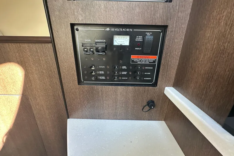 Slide: The Image of 2016 Monterey 295 Sport Yacht interior kitchen with microwave, sink, and storage cabinets. - 56