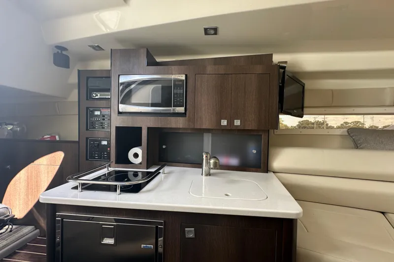 Slide: The Image of Control panel of a 2016 Monterey 295 Sport Yacht featuring audio systems and voltage meter. - 57