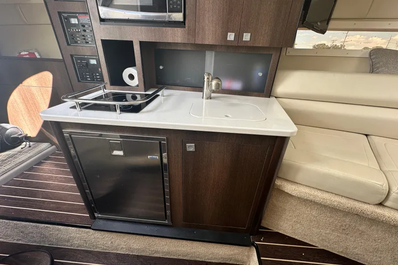 Slide: The Image of Electrical panel inside 2016 Monterey 295 Sport Yacht, featuring shore and generator controls. - 59