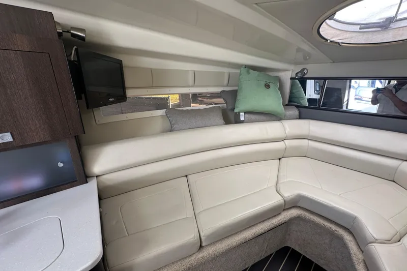 Slide: The Image of 2016 Monterey 295 Sport Yacht interior with kitchenette, featuring sink, stove, and refrigerator. - 62