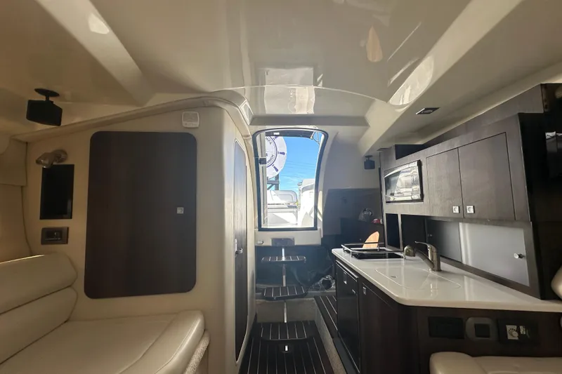 Slide: The Image of Kitchen area of 2016 Monterey 295 Sport Yacht with stove and sink. - 64
