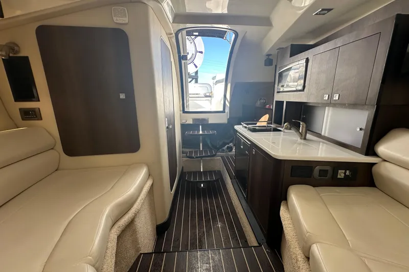 Slide: The Image of Interior of 2016 Monterey 295 Sport Yacht with beige seating and modern amenities. - 65