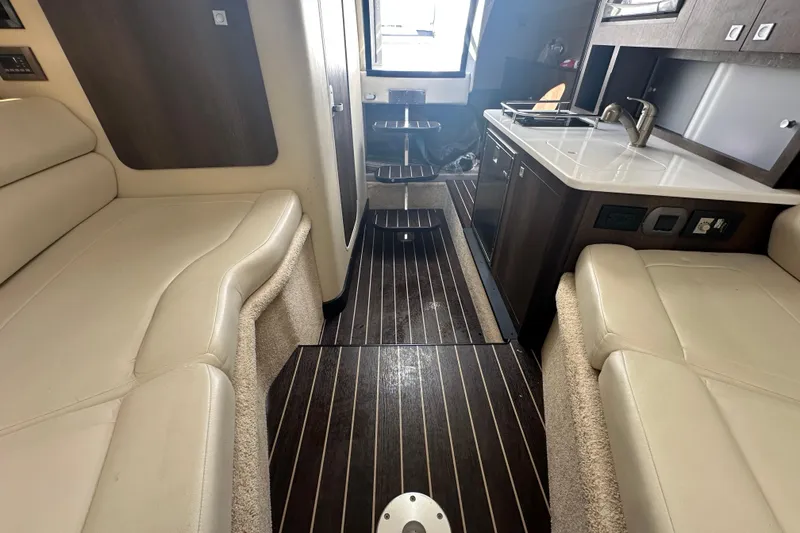Slide: The Image of 2016 Monterey 295 Sport Yacht interior with plush seating and cushions. - 66