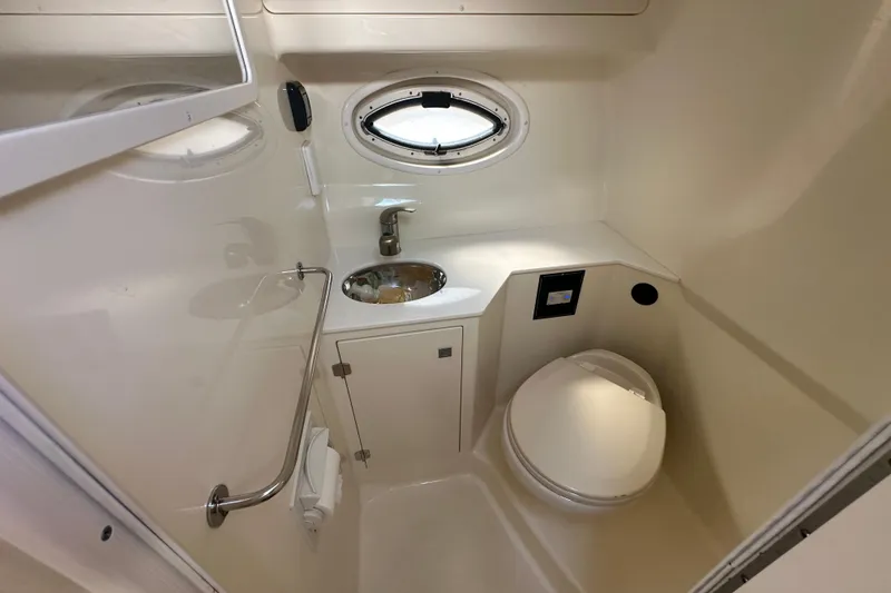 Slide: The Image of 2016 Monterey 295 Sport Yacht interior with kitchenette, seating, and TV. - 72