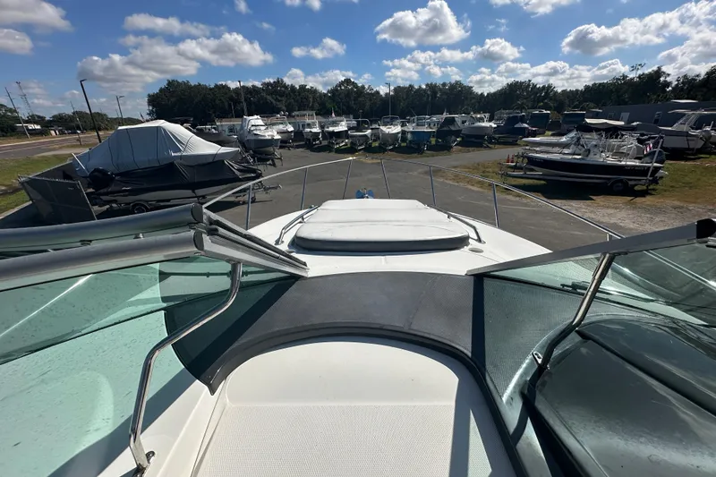 Slide: The Image of 2016 Monterey 295 Sport Yacht bathroom with sink, mirror, and porthole window. - 74