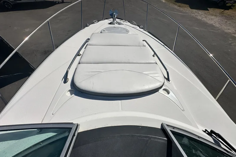 Slide: The Image of 2016 Monterey 295 Sport Yacht in a marina with other boats under a cloudy sky. - 77