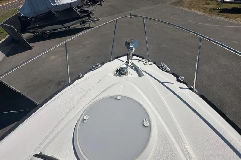 Slide: The Image of 2016 Monterey 295 Sport Yacht deck view with open windshield and sun pad. - 78