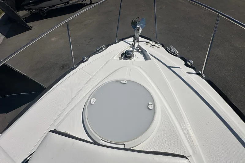 Slide: The Image of 2016 Monterey 295 Sport Yacht bow with sunpad, docked in a marina. - 79