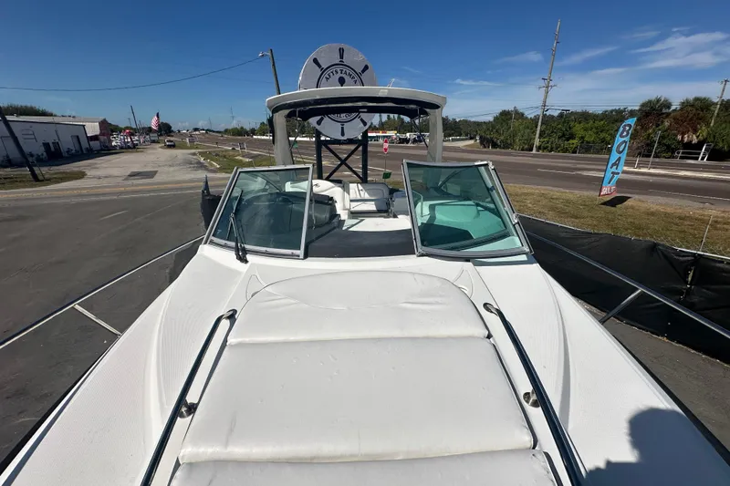 Slide: The Image of 2016 Monterey 295 Sport Yacht deck with sunpad and hatch, docked outdoors. - 84