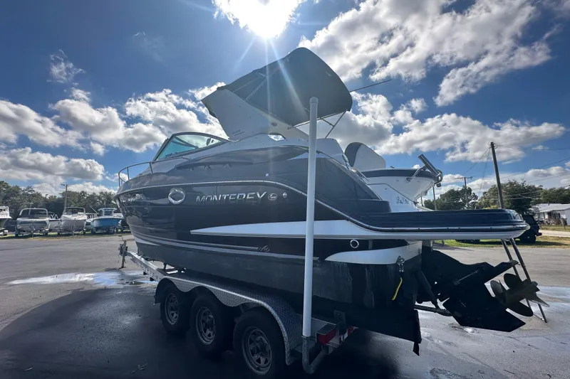 Slide: The Image of 2016 Monterey 295 Sport Yacht on trailer under blue sky. - 9