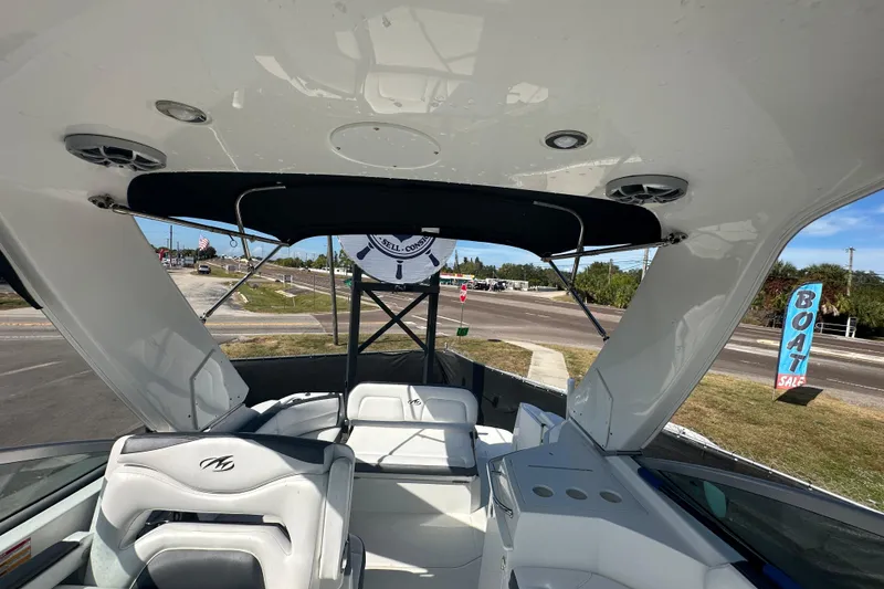 Slide: The Image of 2016 Monterey 295 Sport Yacht interior with sleek seating and modern helm. - 90