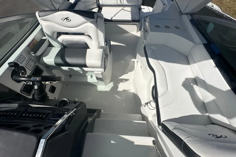 Slide: The Image of 2016 Monterey 295 Sport Yacht interior with seating, canopy, and boat sale sign. - 92