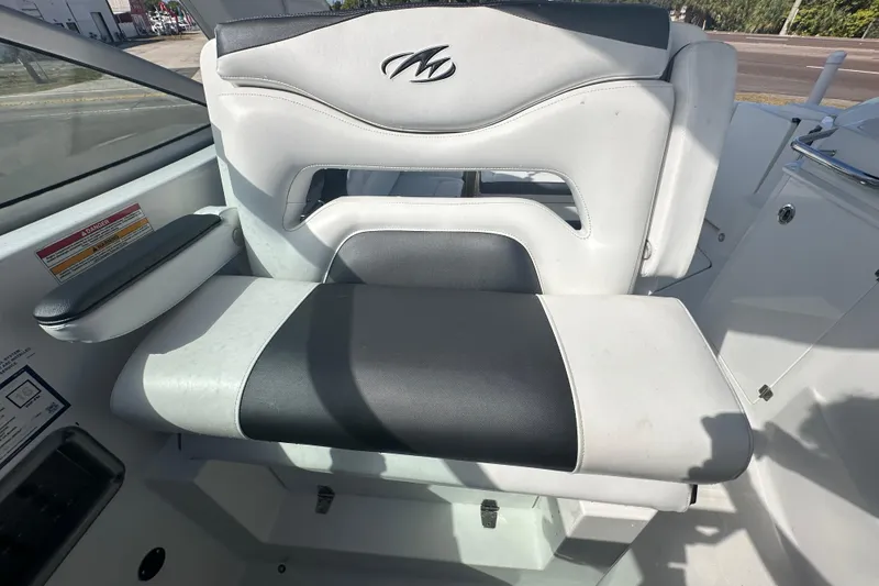Slide: The Image of Interior of a 2016 Monterey 295 Sport Yacht with white seating and modern controls. - 94