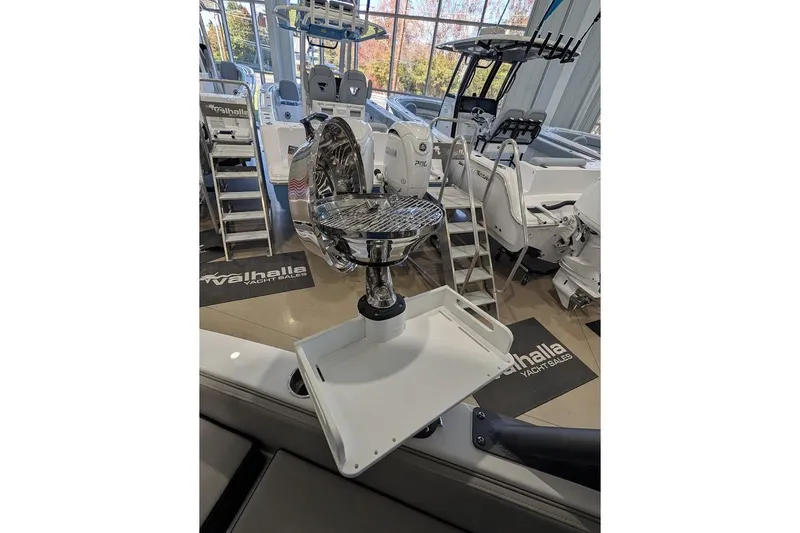 Slide: The Image of 2026 Monterey Elite 25 OB boat interior with fishing chair and equipment display. - 10