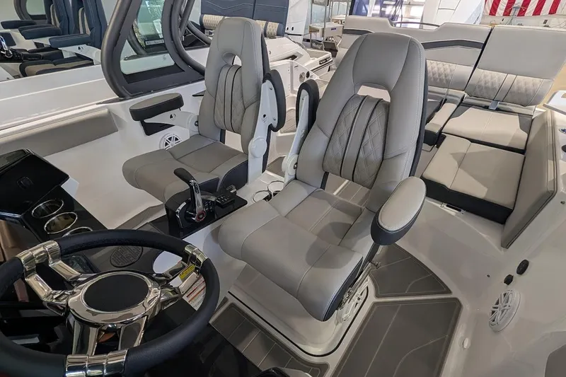 Slide: The Image of 2026 Monterey Elite 25 OB boat interior with luxurious seating and modern steering wheel. - 11