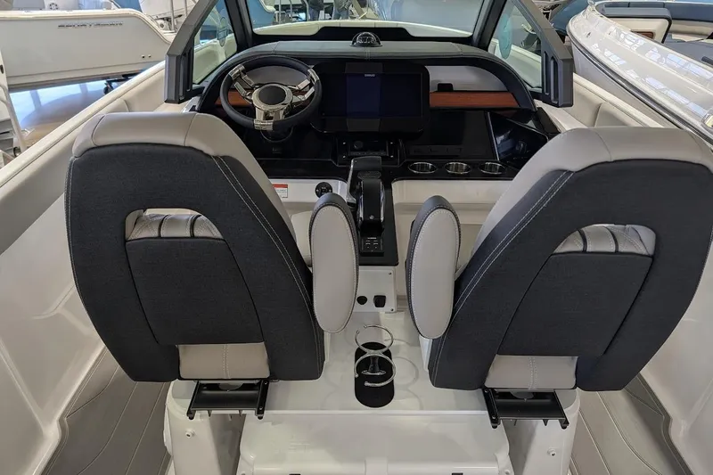 Slide: The Image of 2026 Monterey Elite 25 OB boat interior with modern dashboard and dual seating. - 12