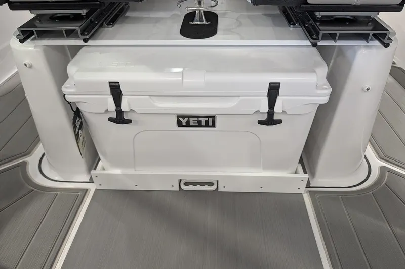 Slide: The Image of YETI cooler on 2026 Monterey Elite 25 OB boat deck, featuring sleek design and storage. - 13
