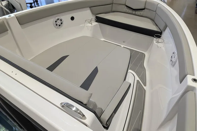 Slide: The Image of 2026 Monterey Elite 25 OB boat interior with cushioned seating and cup holders. - 16