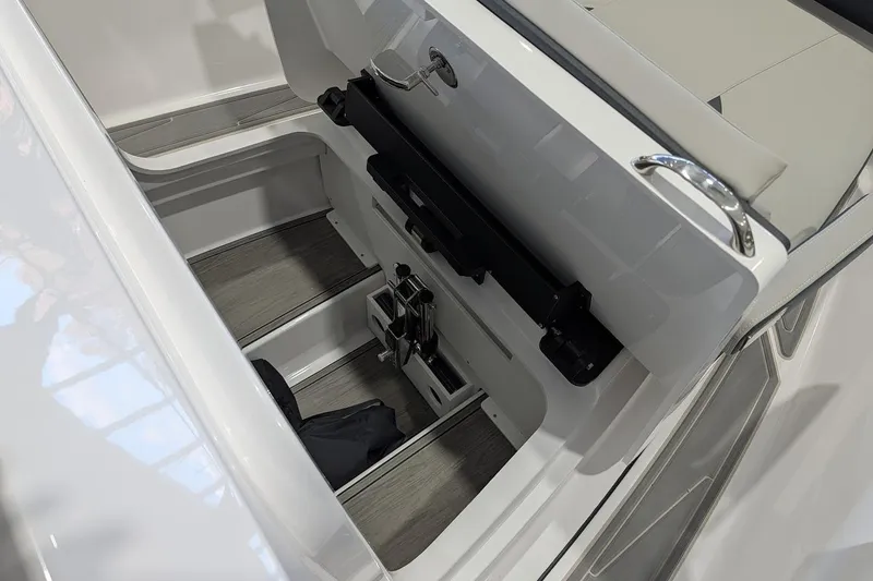 Slide: The Image of 2026 Monterey Elite 25 OB boat storage compartment with sleek design and modern features. - 18