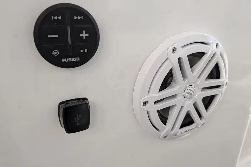 Slide: The Image of Audio controls and speaker on 2026 Monterey Elite 25 OB boat dashboard. - 22