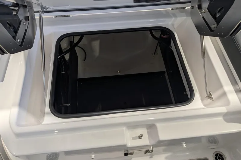 Slide: The Image of Open storage compartment of 2026 Monterey Elite 25 OB boat, showcasing interior space. - 6