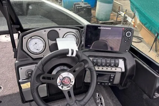Slide: The Image of 2024 Alumacraft Competitor 165 Sport dashboard with steering wheel and Humminbird fish finder. - 4
