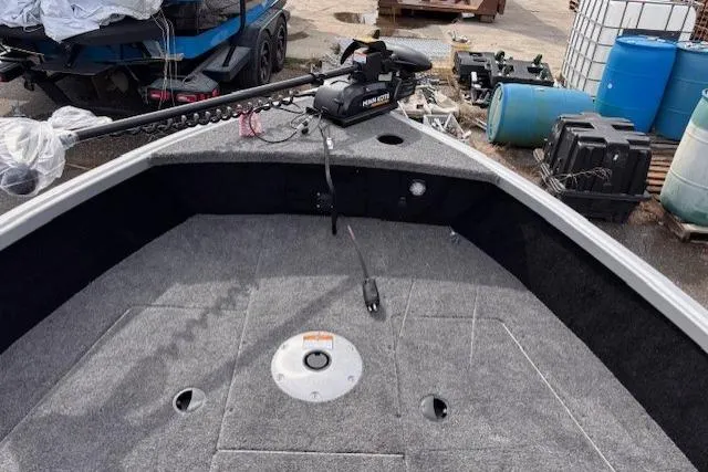 Slide: The Image of 2024 Alumacraft Competitor 165 Sport boat deck with trolling motor and storage compartments. - 7