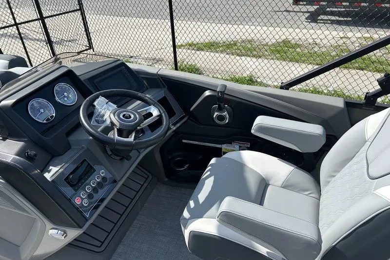 Slide: The Image of 2025 Avalon Catalina Rear Fish boat cockpit with steering wheel and control panel. - 5