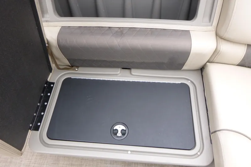 Slide: The Image of 2023 Sun Tracker Party Barge 20 DLX storage compartment with cushioned seating. - 10