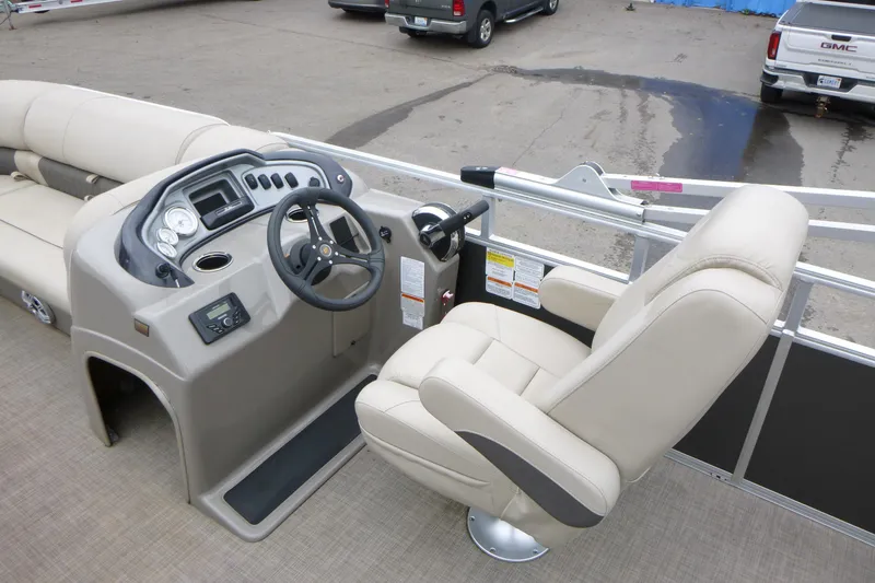 Slide: The Image of 2023 Sun Tracker Party Barge 20 DLX helm with beige captain's chair and control panel. - 12