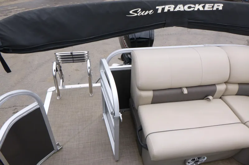 Slide: The Image of 2023 Sun Tracker Party Barge 20 DLX with beige seating and covered canopy. - 7
