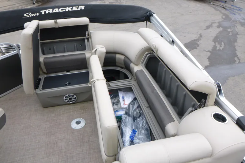 Slide: The Image of 2023 Sun Tracker Party Barge 20 DLX interior with open storage compartments. - 9