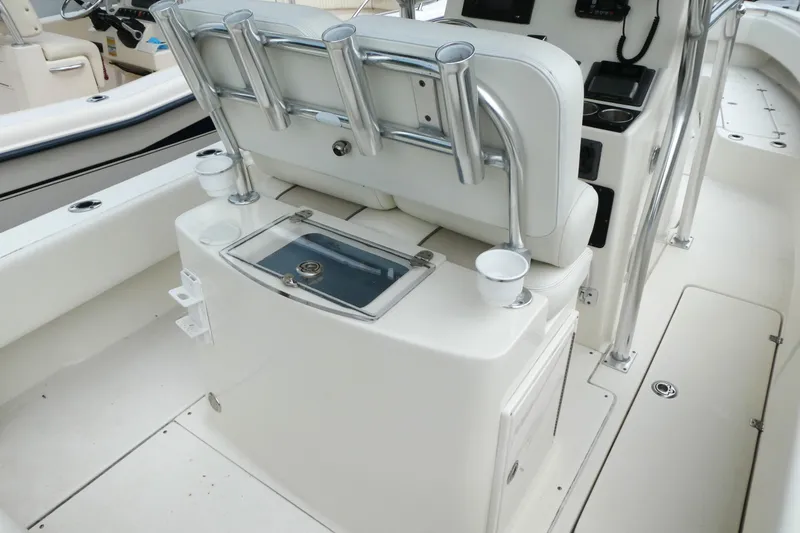 Slide: The Image of 2012 ShearWater 26 boat interior with rod holders and storage compartments. - 11