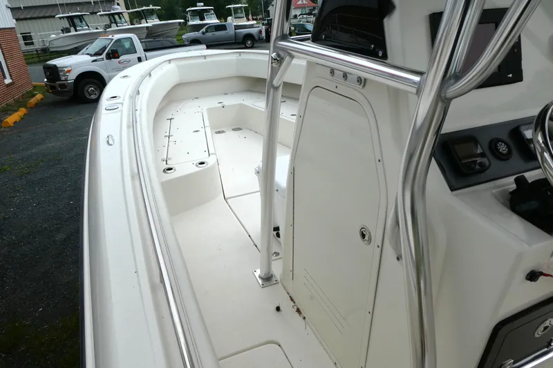 Slide: The Image of 2012 ShearWater 26 boat interior with steering console and seating area. - 14