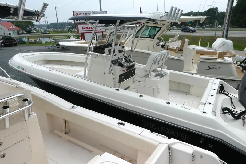 Slide: The Image of 2012 ShearWater 26 boat with center console, docked at a marina. - 5