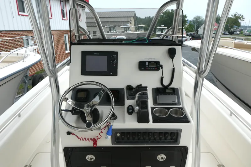 Slide: The Image of 2012 ShearWater 26 boat console with steering wheel, navigation equipment, and controls. - 6
