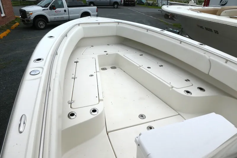 Slide: The Image of 2012 ShearWater 26 boat interior with spacious deck and storage compartments. - 7