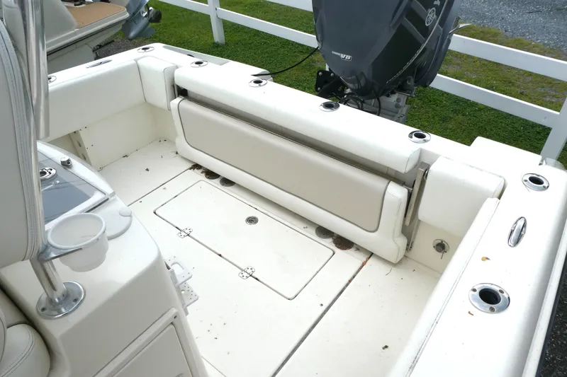 Slide: The Image of 2012 ShearWater 26 boat interior with seating and outboard motor. - 9