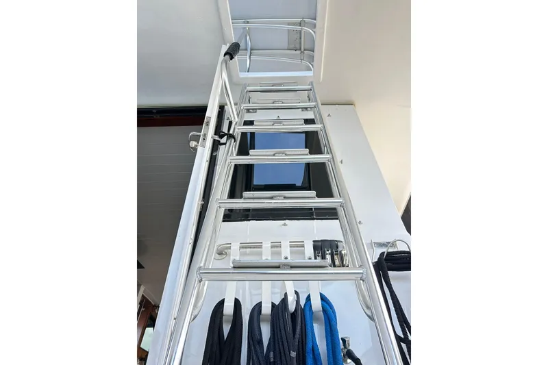 Slide: The Image of Ladder on 1979 Hatteras 53 Motor Yacht Hard Top, with ropes hanging below. - 103