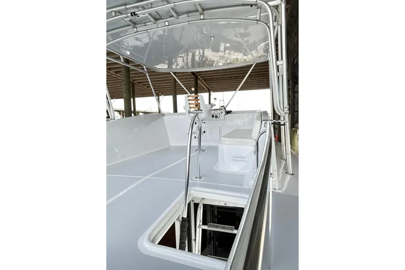 Slide: The Image of 1979 Hatteras 53 Motor Yacht Hard Top deck with helm and seating area. - 104