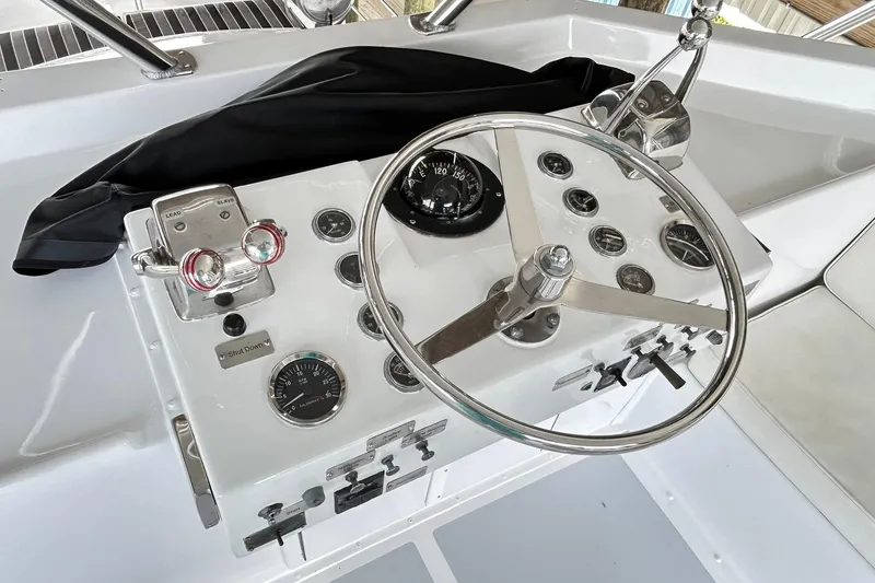 Slide: The Image of 1979 Hatteras 53 Motor Yacht Hard Top helm with steering wheel and control panel. - 105