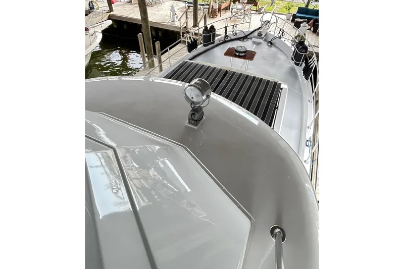 Slide: The Image of 1979 Hatteras 53 Motor Yacht Hard Top, docked with visible deck and spotlight. - 109