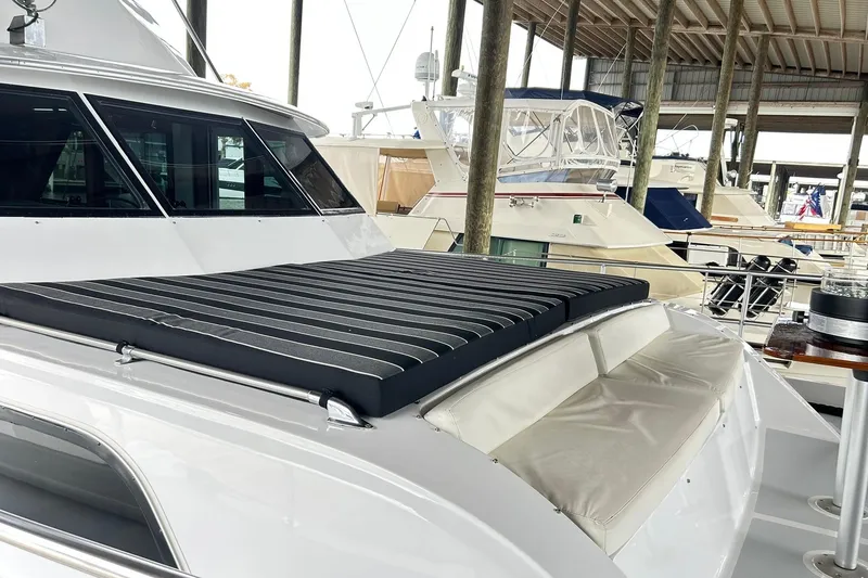 Slide: The Image of 1979 Hatteras 53 Motor Yacht Hard Top docked, featuring sleek design and comfortable seating. - 111